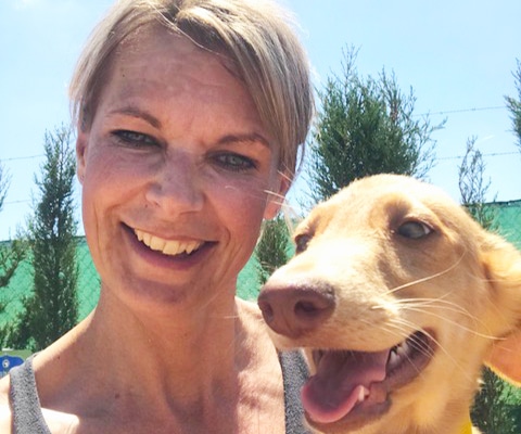 Helen cuddling a puppy